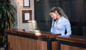 women at hotel receptionist desk on the phone