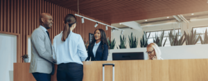 two people checking into a hotel at the front desk