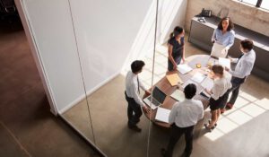 Business group in meeting room all standing up