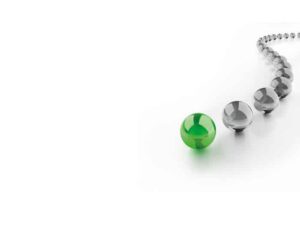 photo of a green glass ball with gray glass balls behind it in a wavy line