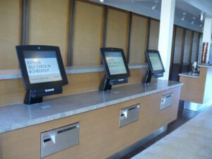 computer monitors in a hotel offering express self check-in and checkout options for guests